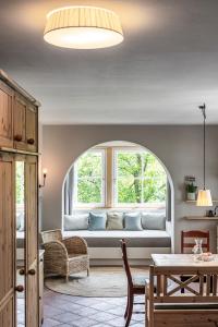 a living room with a couch in front of a window at Villa Gloria in Soprabolzano