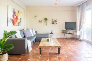 a living room with a couch and a coffee table at Sani villa perfect for family vacations in Sani Beach