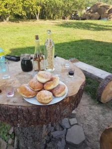 a table with a plate of bagels on it at Casuța din Grădină in Breb +54 photos