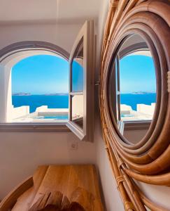 a mirror in a room with a view of the ocean at Kokkinos Villas in Akrotiri