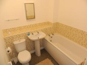 a bathroom with a sink and a tub and a toilet and a sink at Baird House in Thornaby on Tees