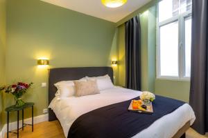 a bedroom with a bed with a tray on it at Les appartements chics du Vieux-Port in Marseille
