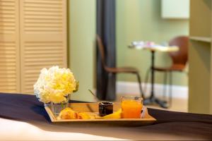 a tray of food and a glass of orange juice at Les appartements chics du Vieux-Port in Marseille