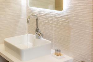 a bathroom with a white sink and a mirror at Les appartements chics du Vieux-Port in Marseille