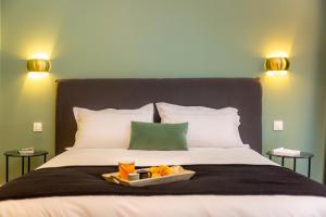 a bed with a tray of fruit on it at Les appartements chics du Vieux-Port in Marseille