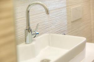 a sink with a faucet on top of it at Les appartements chics du Vieux-Port in Marseille