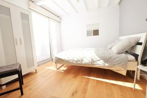 a bedroom with a bed and a large window at Escale de 80 m2 avec cour et parking in Lille