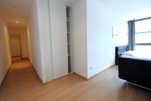 an empty room with a bed and a closet at Appartement Gare Lille Europe in Lille