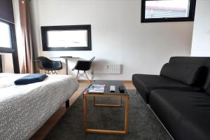 a living room with a couch and a table at Appartement Gare Lille Europe in Lille