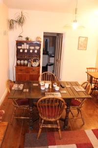 a dining room with a wooden table and chairs at Norfolk Guest House in Bristol