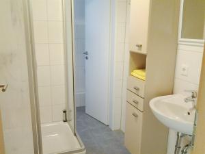 a bathroom with a sink and a toilet and a shower at Maffei Apartments in Nürnberg