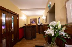 a room with a reception desk and a vase of flowers at The Auld Kirk in Ballater