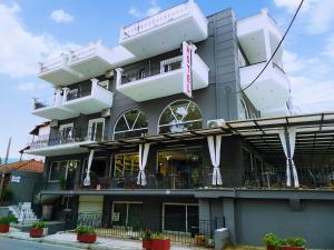 a building with balconies on the side of it at Hotel Evagelia in Leptokarya