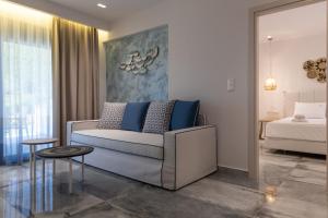 a living room with a couch and a bed at Notia Luxury Living in Porto Koufo