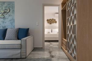 a living room with a couch and a bedroom at Notia Luxury Living in Porto Koufo