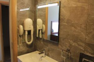 a bathroom with a sink and a mirror at Alâ Avsa Hotel in Avşa Adası