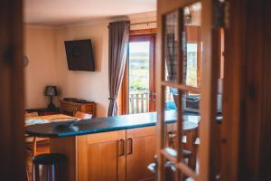 a kitchen with a counter top and a table at Moorpark Cottages in Barvas