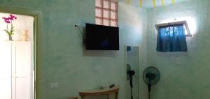 a room with a flat screen tv on the wall at La Casa Dei Delfini in Lampedusa