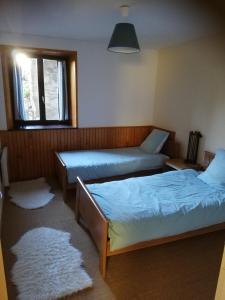 a room with two beds and a window at gite les chaumeix in Prondines