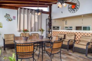 a patio with a wooden table and chairs at Hotel Bucaneros Isla Mujeres in Isla Mujeres