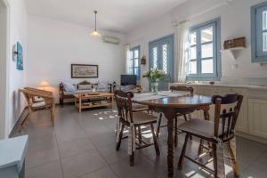 a kitchen and living room with a table and chairs at Vista Mare Pollonia in Pollonia +19 photos