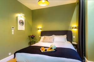 a bedroom with a large bed with a tray on it at Les appartements chics du Vieux-Port in Marseille