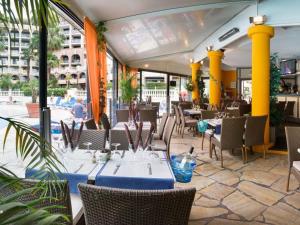 a restaurant with tables and chairs in a building at #Cannes Boccacabana Beach, Seafront, in Résid Pierre&Vacances 3 Stars in Cannes
