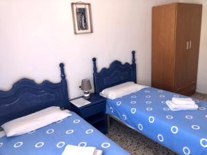 A bed or beds in a room at Pensión Playa