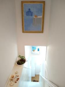a stairway with a painting and shells on the floor at Hermoupolis Syros Maisonette in Ermoupoli