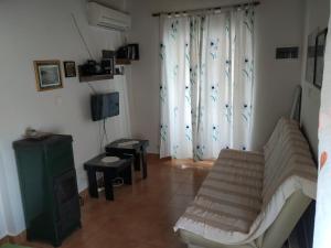 a living room with a couch and a television at Apartment Anka in Savar