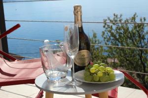 a table with a bottle of wine and wine glasses at Blue Art Apartment in Sveti Juraj