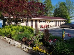 a flower garden in front of a building at Square Rigger Harbor Motel in Baileys Harbor