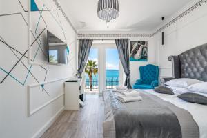 a bedroom with a bed with a view of the ocean at Galeria Valeria Seaside Downtown - MAG Quaint & Elegant Boutique Hotels in Split