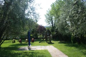 a playground in a park with a slide and trees at Residence Miralago Rooms & Apartments in Manerba del Garda