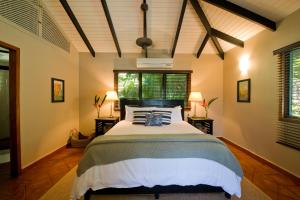 a bedroom with a large bed in a room at Copal Tree Lodge a Muy'Ono Resort in Toledo Settlement