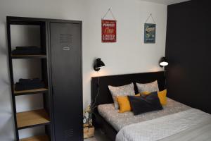 a bedroom with a bed with yellow pillows at Cosy apartment in the center of Brussels in Brussels