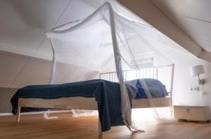 Un pat sau paturi într-o cameră la Tulpenhoek