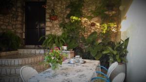 a table with a vase of flowers on it at Holiday house Belavista in Novi Vinodolski