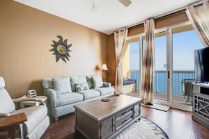 a living room with a couch and a tv at Calypso Resort 2 in Panama City Beach