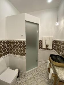 a bathroom with a toilet and a sink at Nabat Palace Arbat in Moscow