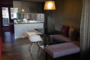 a living room with a table and a kitchen at VISION APARTMAN in Sárvár