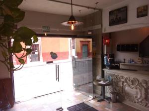 a kitchen with a large glass door in a room at Hotel Santa Ana in San Miguel de Allende