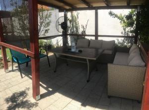 a patio with a couch and a table and chairs at Apartments Kristal in Kaštela