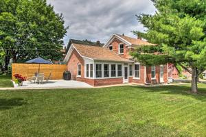 a brick house with a patio and a yard at Historic Wabasha Home with Patio in Downtown! in Wabasha
