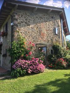 a stone building with flowers in front of it at Il Mugello B&B in Vicchio