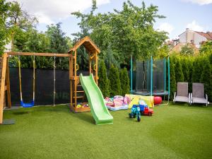 a childrens playground with a slide and a swing set at Čajkovskij Apartments in Brno