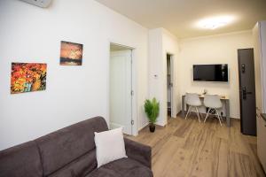 a living room with a couch and a table at Covaciu aparthotel in Cluj-Napoca