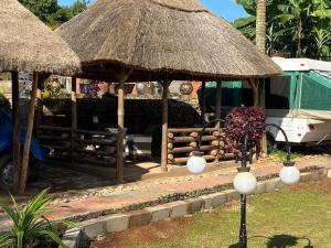 a resort with aiki umbrellas and a table at Lake Victoria Country Home in Entebbe