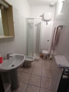 a bathroom with a sink and a shower and a toilet at Camere la torre in Volterra