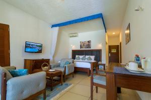 a living room with a couch and a table at Travellers Beach Hotel in Mombasa